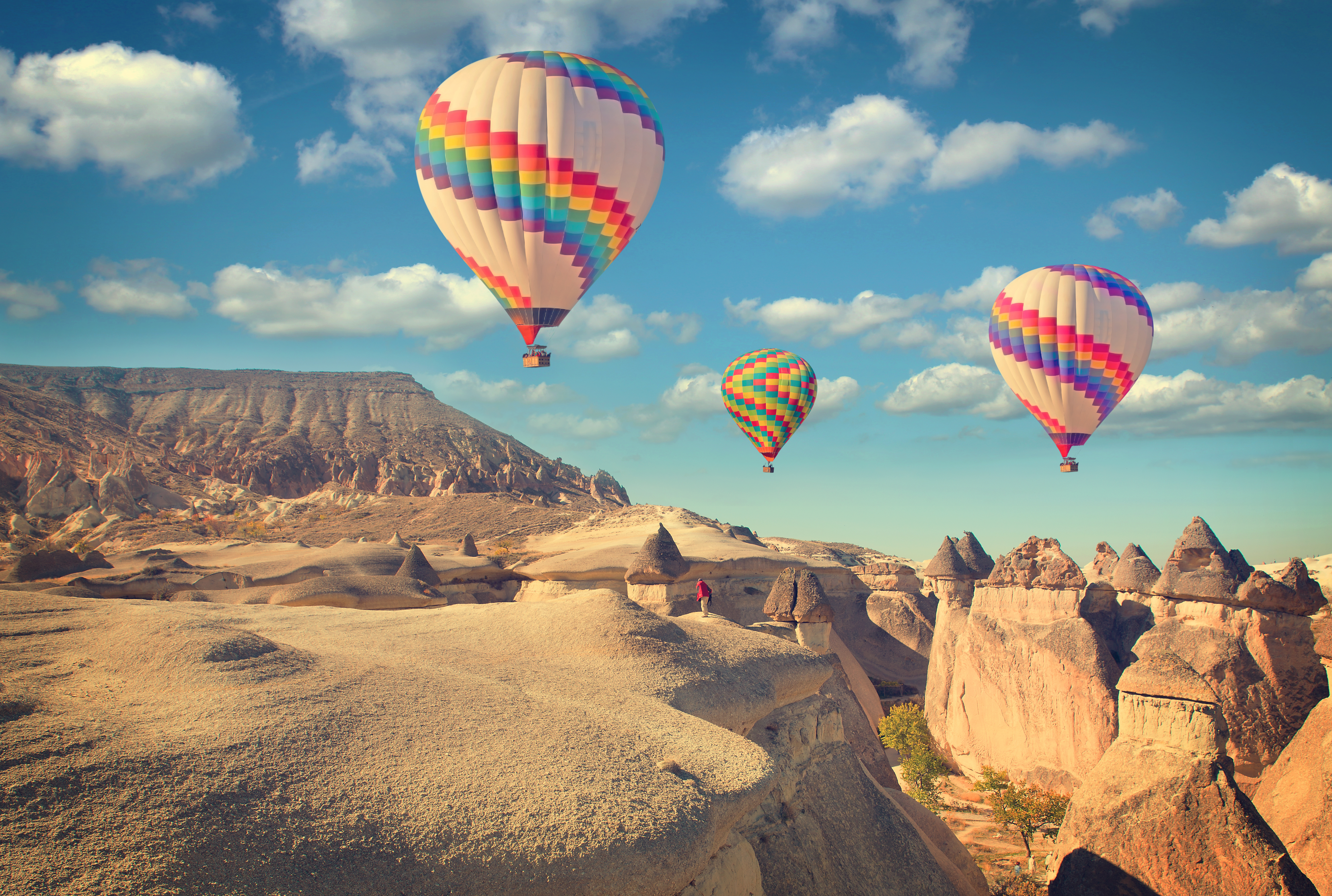 hot air balloon flying over rock landscape at Cappadocia Turkey