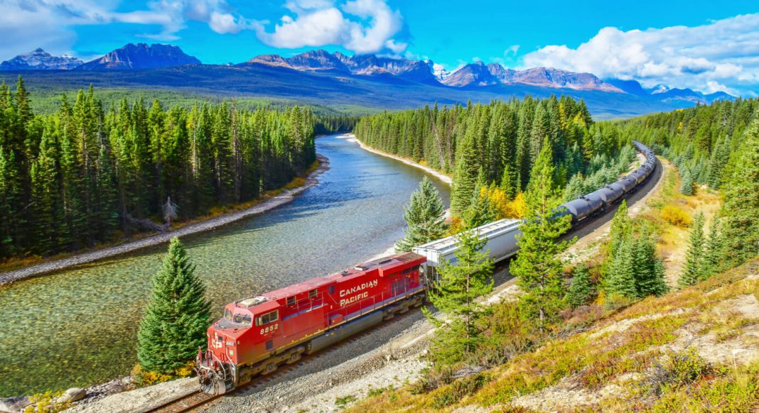 Long freight train Canadian Pacific Railway moving along Bow river in Canadian Rockies ,Banff National Park, Canadian Rockies,Canada.